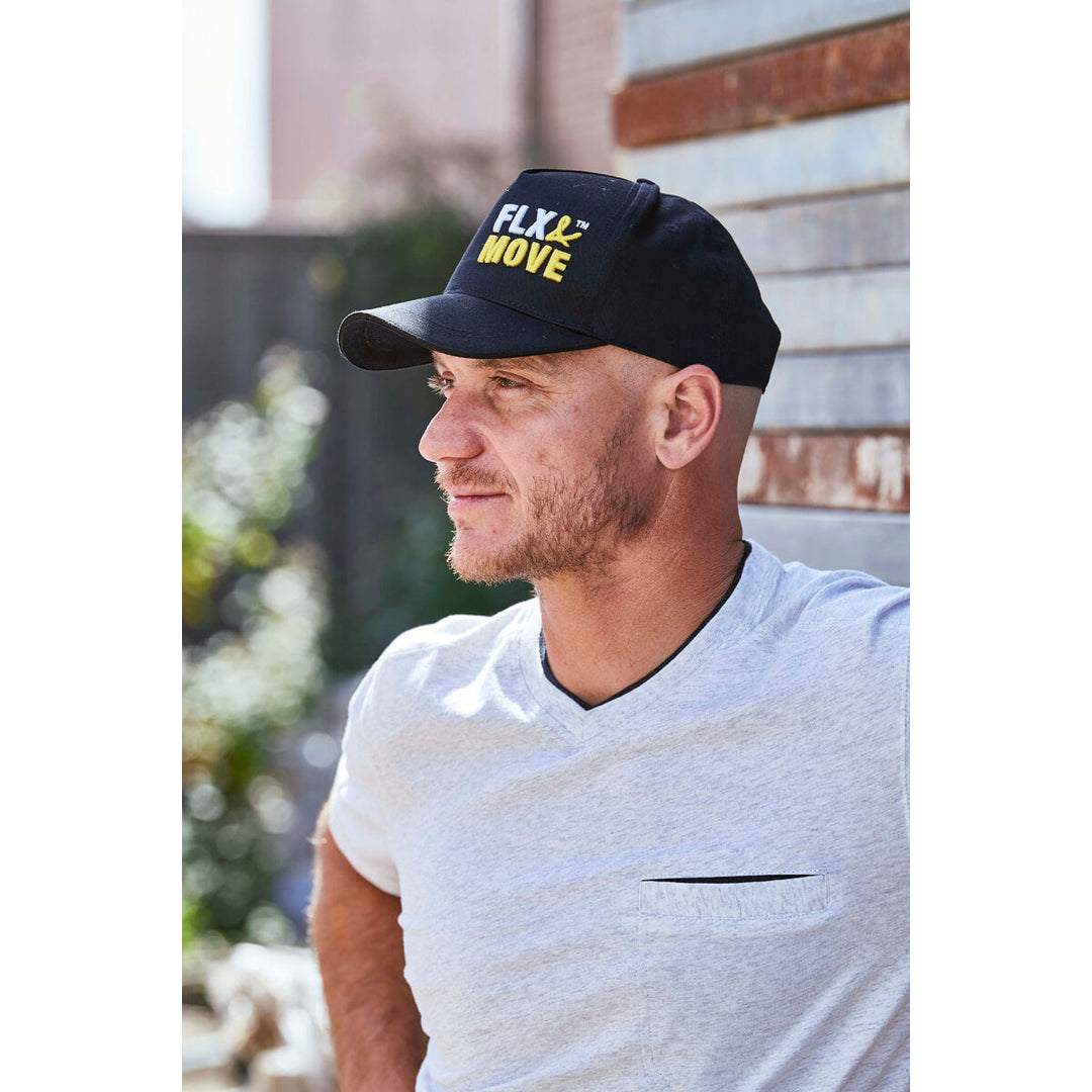 Man wearing a black Bisley BCAP70 cap with 'FLX MOVE' text, outdoors.