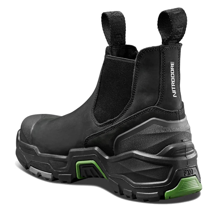 A black safety Chelsea boot with a chunky, rugged sole featuring bright green accents, shown from a three-quarters angle on a white background.