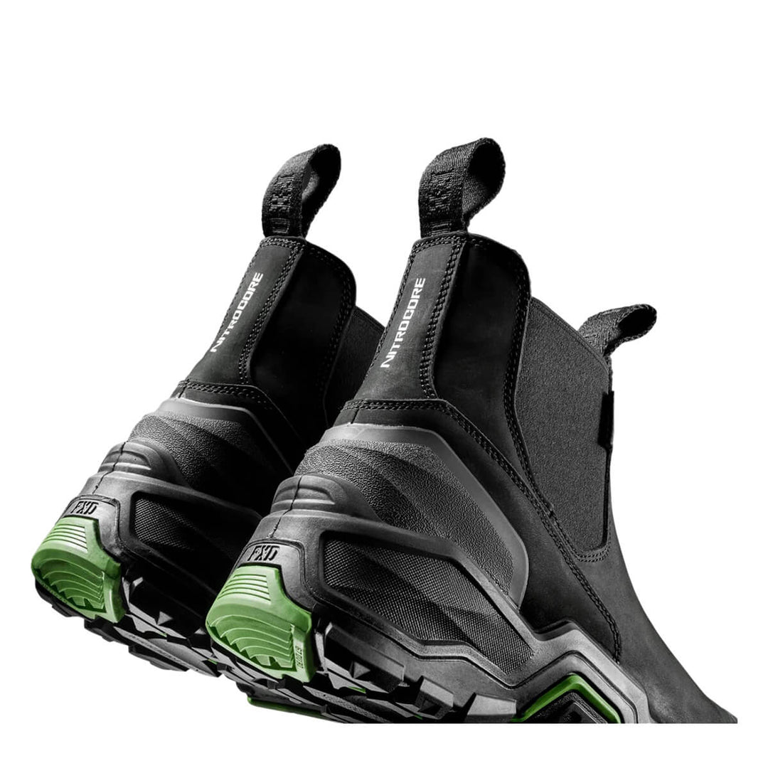 A pair of black boots with chunky black and gray soles and green accents on the outsole, shown on a plain white background.